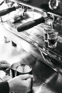 Cropped hand of barista preparing coffee