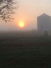 Scenic view of field against sky during sunset