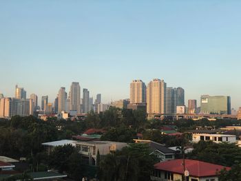 Buildings in city against clear sky