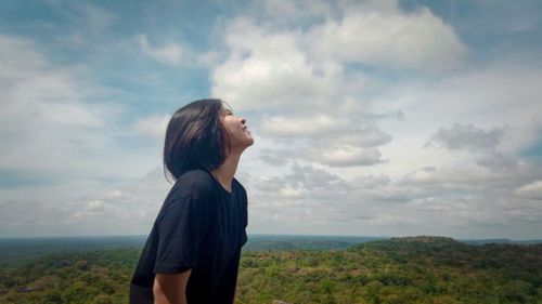 Man looking at camera against sky