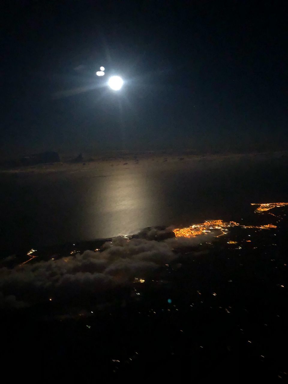 ILLUMINATED CITY AGAINST SKY AT NIGHT