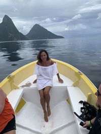 Woman in boat on lake against sky