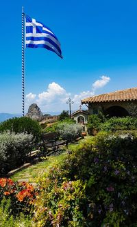 Scenic view of flag against blue sky