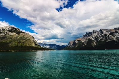 Scenic view of sea and mountains against sky