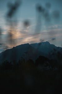 Scenic view of silhouette mountains against sky at sunset