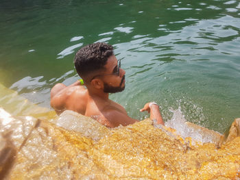 High angle view of boy swimming in water