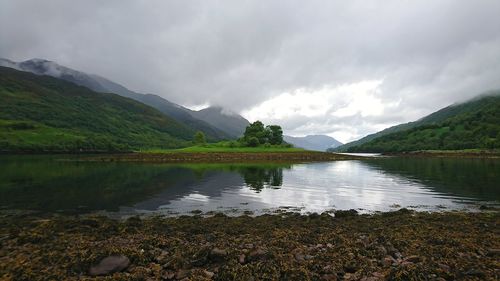 Scenic view of lake and mountains against sky