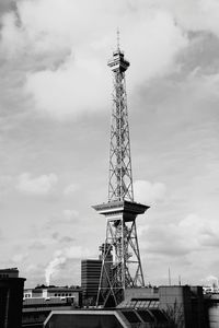 Low angle view of communications tower against sky