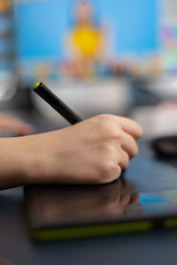 Close-up of hand holding table