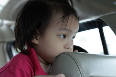 Close-up of girl sitting in car