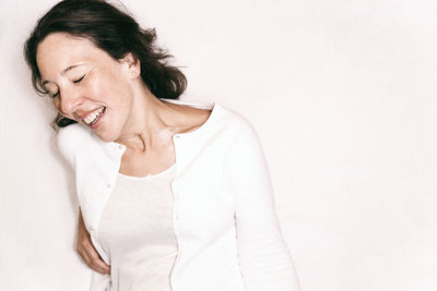 Smiling woman lying on bed at home