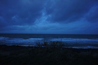 Scenic view of sea against cloudy sky