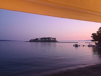 Scenic view of sea against clear sky during sunset