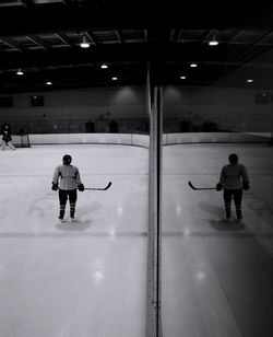 Full length of man playing ice rink