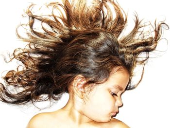 High angle view of girl with fanned out hair on white background