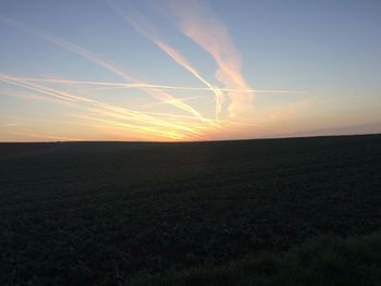 Scenic view of field against sky during sunset