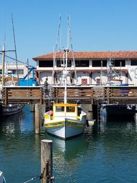 Boats moored at harbor