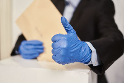 Close-up of man doing thumbs up