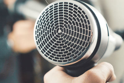 Close-up of hand holding hair dryer