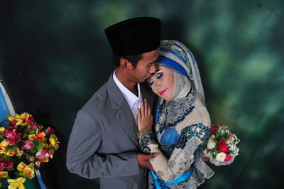 Young couple kissing on flower