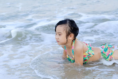 Full length of woman looking at beach