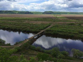 Scenic view of agricultural landscape against sky