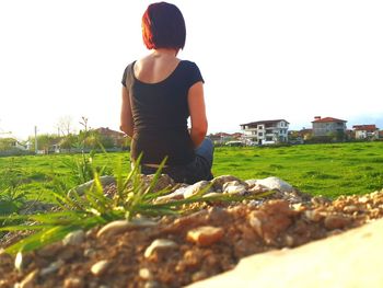 Woman standing on grassy field