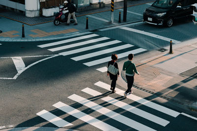 High angle view of people crossing road