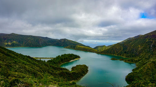 Scenic view of lake and mountains against sky