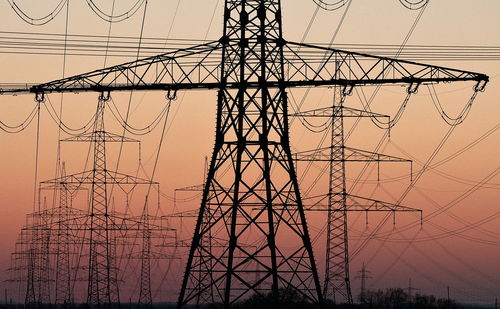 Low angle view of electricity pylon against sky