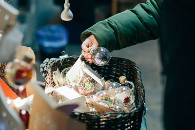 Close-up of hand holding christmas toys at market