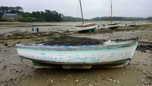 Boats moored on shore