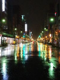 Wet illuminated road during rainy season at night