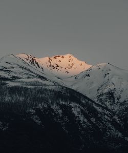 Scenic view of snowcapped mountains against clear sky