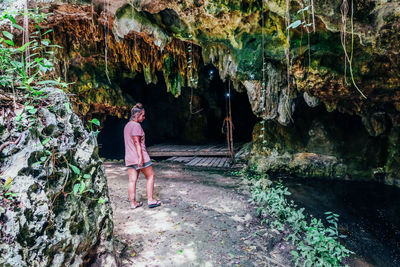 Man standing on rock in cave