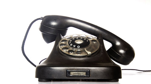 Close-up of telephone booth against white background