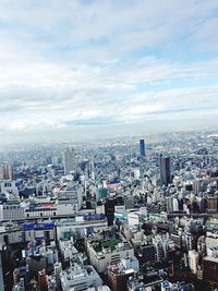 Cityscape against cloudy sky