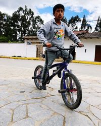 Portrait of young man riding bicycle