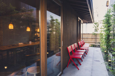 Empty chairs and tables in restaurant against building