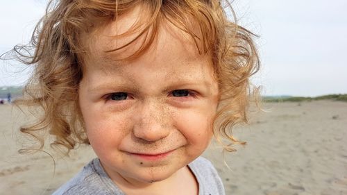 Close-up portrait of smiling girl on beach
