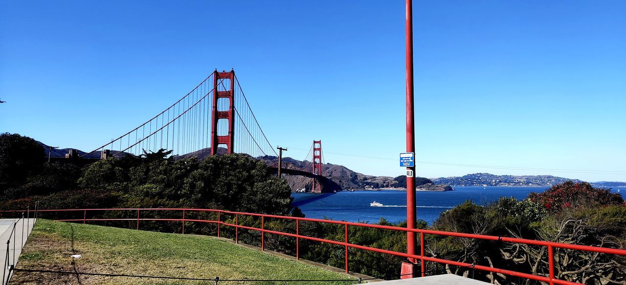 BRIDGE OVER RIVER AGAINST BLUE SKY