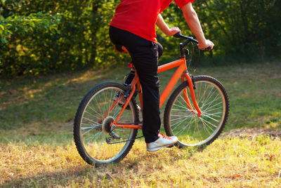 Low section of person riding bicycle on road