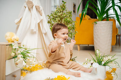 Portrait of cute girl blowing flowers