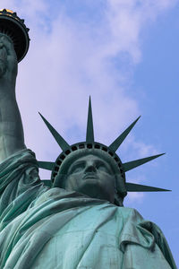 Low angle view of statue of liberty against sky