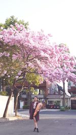 Woman with pink flowers on tree