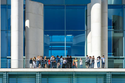 People in front of modern building