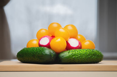 Ingredients for fresh vegetable salad close-up on a wooden table. a pile of various raw organic