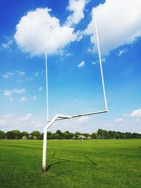 Rugby scoring posts on sportsfield with blue sky and clouds in sunshine