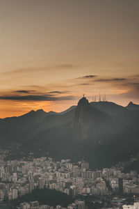 Buildings in city against sky during sunset