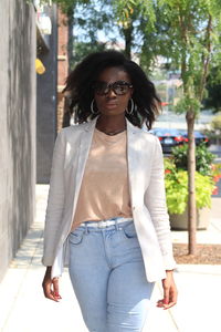 Portrait of woman wearing sunglasses standing outdoors